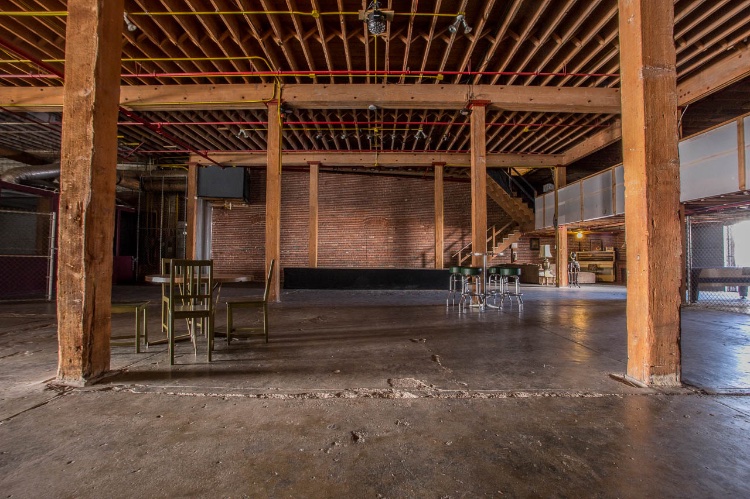 Warehouse Location with Different Spaces: Warehouse containing many different spaces. This listing is only One Floor of the property, which includes all of the following (you can use everything on this floor for the rate stated): Industrial Warehouse which can be turned into a Club, has a Bar setting and a Stage setting, The Arcade Room, The Cage, Elevator, VIP area, Big Loading Dock, Piano Lounge, Artists Apartment with Brick walls, Production Space and Make Up room. 
                        
                        NOTE: rental of this floor can be combined with anything below and will have a discount.
                        
                        To see different spaces on the other floor, follow this link: 
                        https://locations.film/location/433
                        
                        To see rooftop, follow this link: 
                        https://locations.film/location/455
                        
                        To see alley, follow this link:
                        https://locations.film/location/456